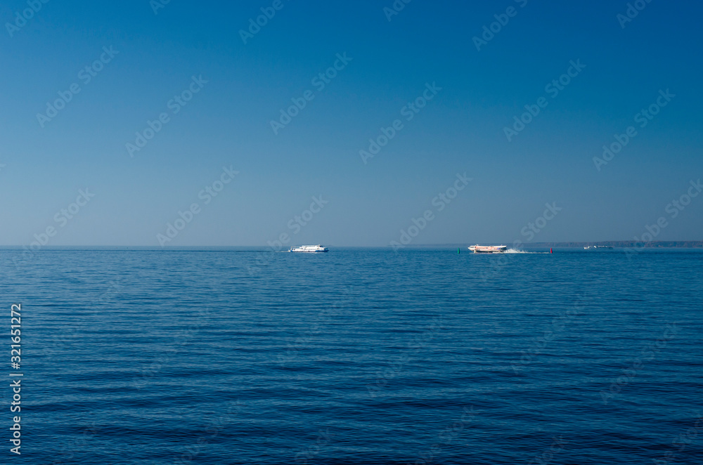 Sea panorama with blue expanse of water and blue sky. Sea skyline with a tall glass skyscraper. The tallest building in Europe. St. Petersburg, Lakhta Center, Russia, May 1, 2019