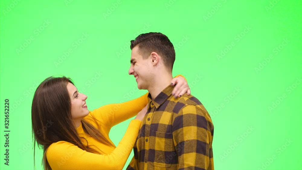 Tender loving couple meet on a green background. Boy is waiting for his girlfriend. Close up. Copy space. 4K. Tender loving couple meet on a green background. Boy is waiting for his girlfriend. Close up. Copy space. 4K.