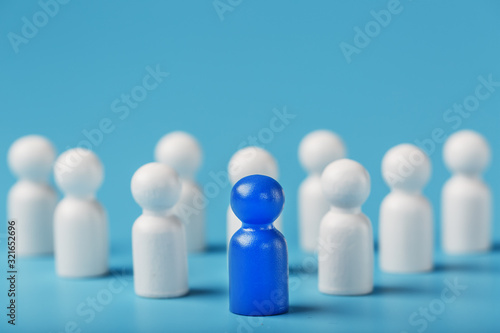 The leader in blue leads a group of white employees to victory, HR, Staff recruitment. The concept of leadership.