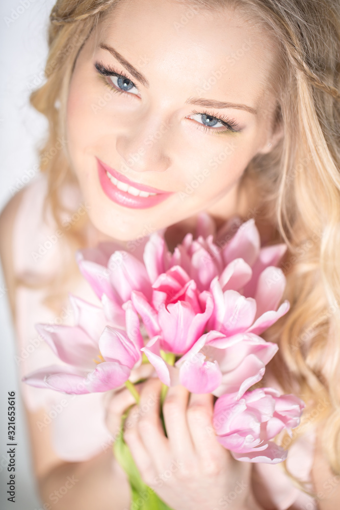 Luxurious blonde with a bouquet of tulips Luxurious blonde with a bouquet of tulips