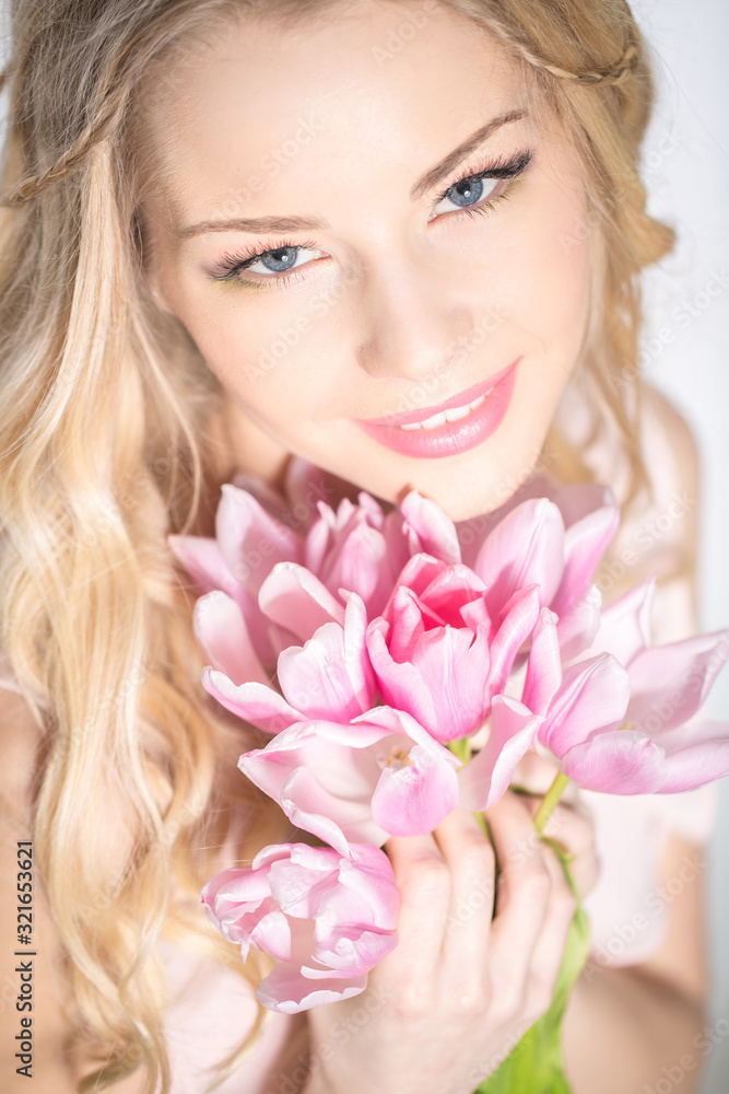 Luxurious blonde with a bouquet of tulips Luxurious blonde with a bouquet of tulips
