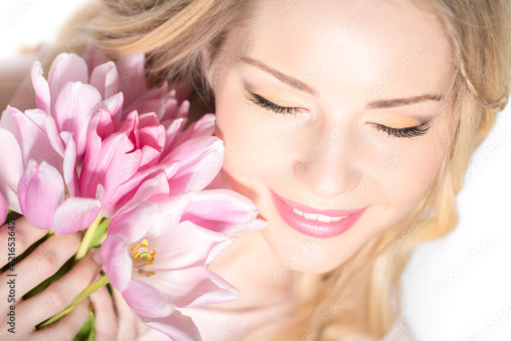 Luxurious blonde with a bouquet of tulips Luxurious blonde with a bouquet of tulips