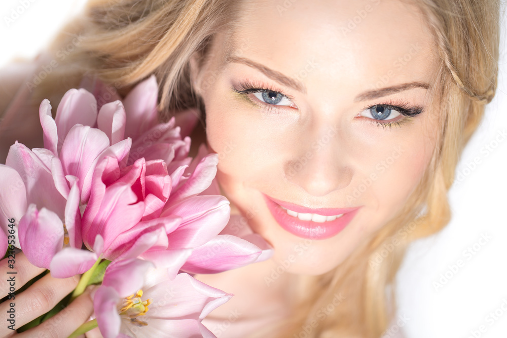 Luxurious blonde with a bouquet of tulips Luxurious blonde with a bouquet of tulips