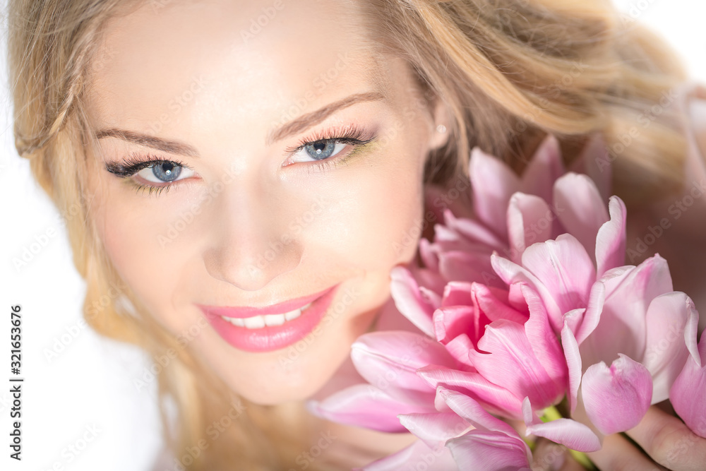 Luxurious blonde with a bouquet of tulips Luxurious blonde with a bouquet of tulips