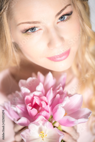 Luxurious blonde with a bouquet of tulips