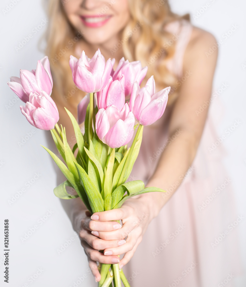 Luxurious blonde with a bouquet of tulips