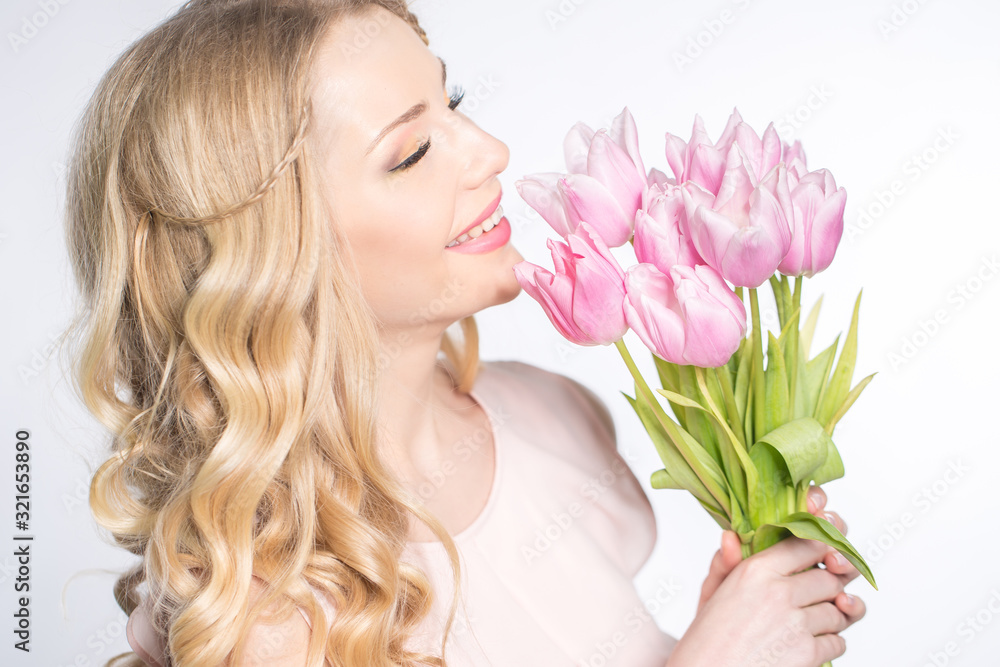 Luxurious blonde with a bouquet of tulips