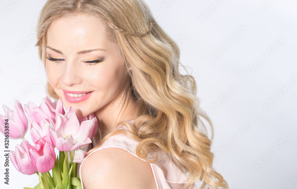 Luxurious blonde with a bouquet of tulips Luxurious blonde with a bouquet of tulips