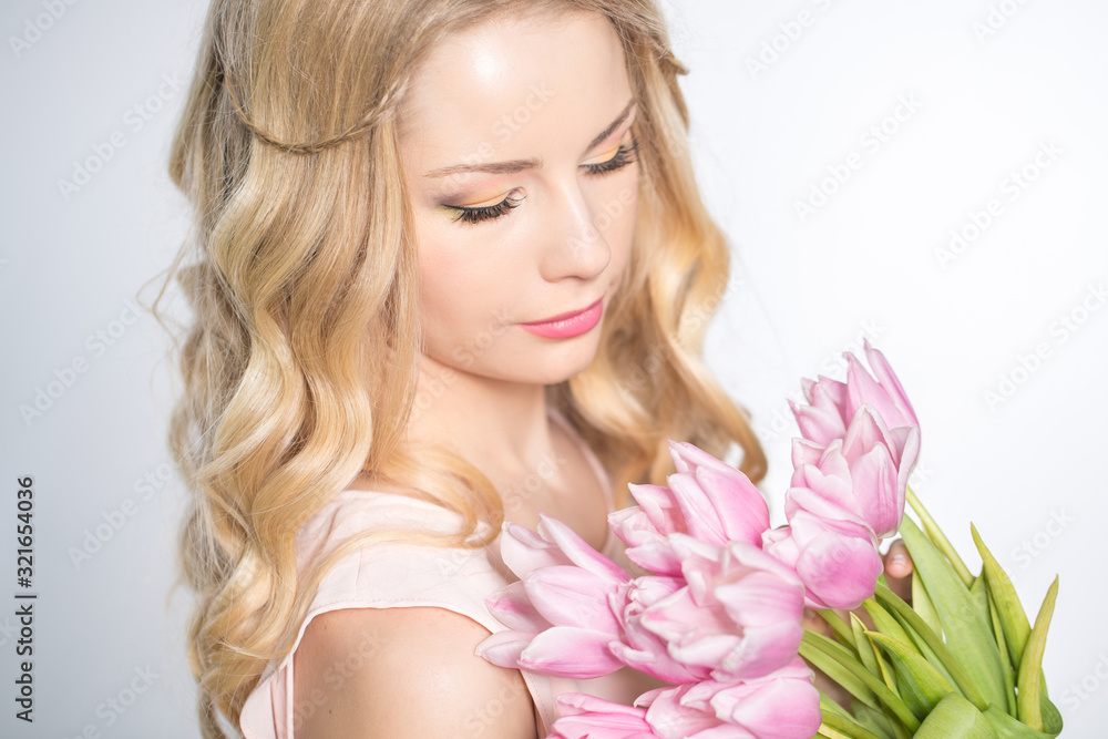 Luxurious blonde with a bouquet of tulips