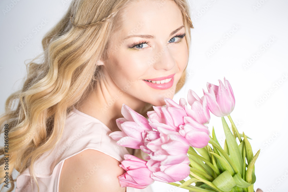 Luxurious blonde with a bouquet of tulips