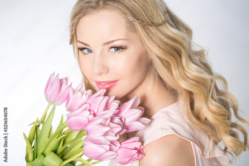 Luxurious blonde with a bouquet of tulips Luxurious blonde with a bouquet of tulips