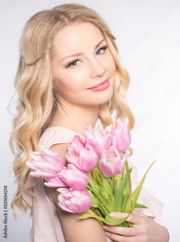 Luxurious blonde with a bouquet of tulips