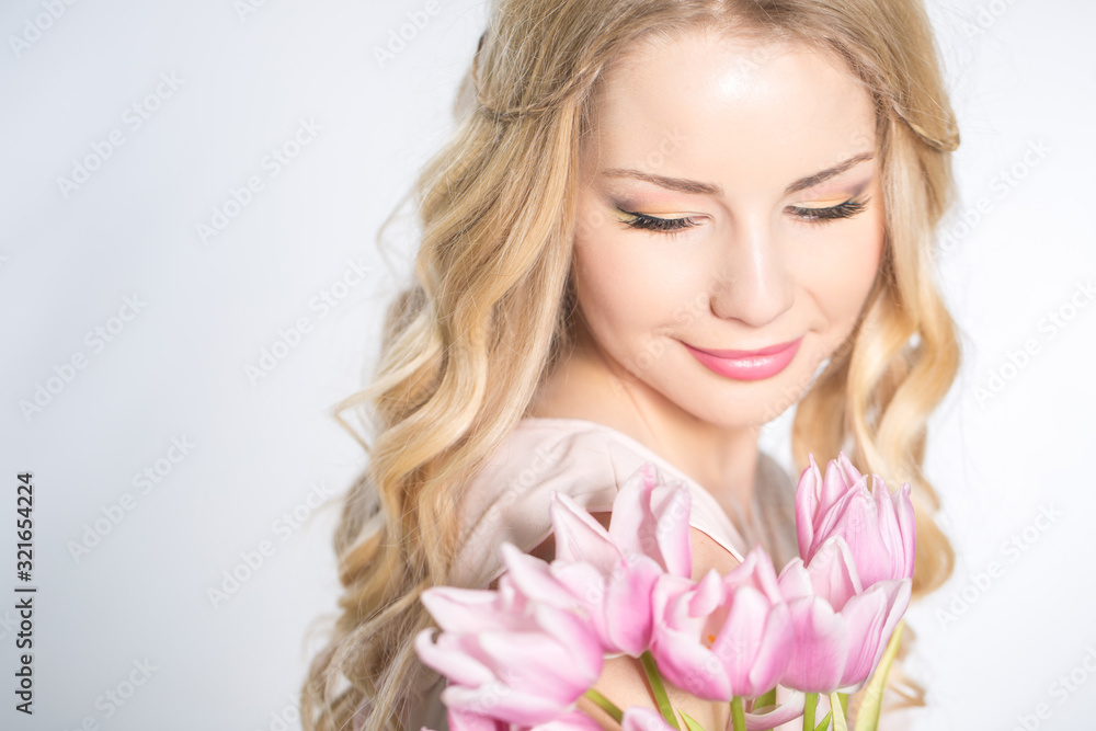 Luxurious blonde with a bouquet of tulips Luxurious blonde with a bouquet of tulips