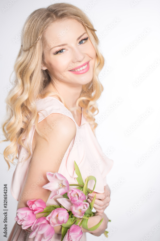 Luxurious blonde with a bouquet of tulips Luxurious blonde with a bouquet of tulips
