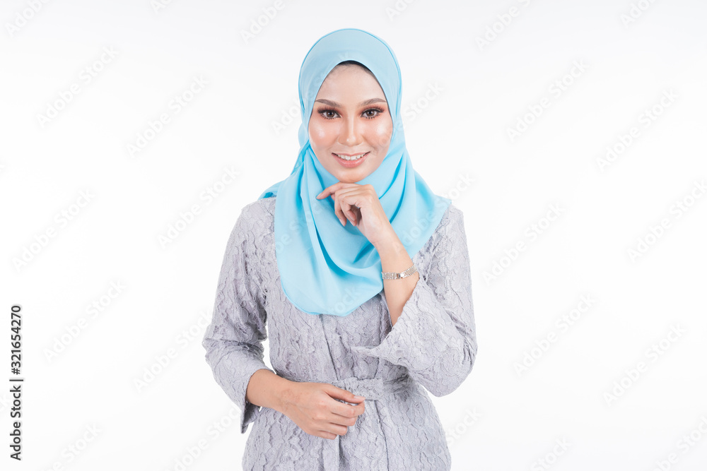 Beautiful female model in various poses wearing modern kebaya and hijab, a urban lifestyle apparel for Muslim women isolated on white background. Beauty and hijab fashion concept. Half length. Beautiful female model in various poses wearing modern kebaya and hijab, a urban lifestyle apparel for Muslim women isolated on white background. Beauty and hijab fashion concept. Half length.