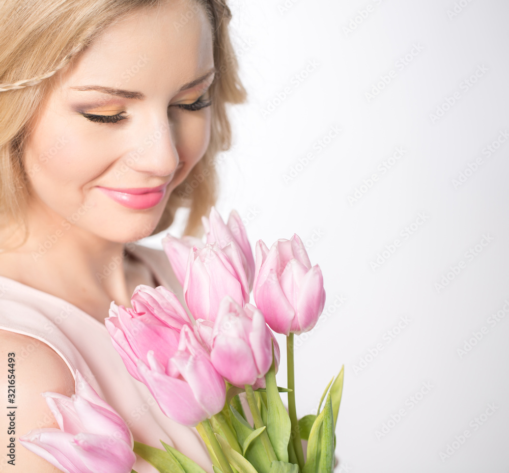Luxurious blonde with a bouquet of tulips Luxurious blonde with a bouquet of tulips