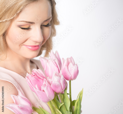 Luxurious blonde with a bouquet of tulips