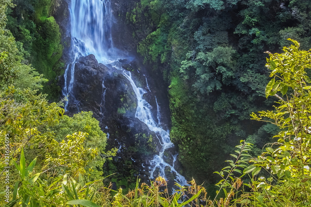 view of silky water falling attack the rock with green tree on high cliff background, Mae Surin Waterfall, Namtok Mae Surin National Park, Mae Hong Son, northern of Thailand. view of silky water falling attack the rock with green tree on high cliff background, Mae Surin Waterfall, Namtok Mae Surin National Park, Mae Hong Son, northern of Thailand.