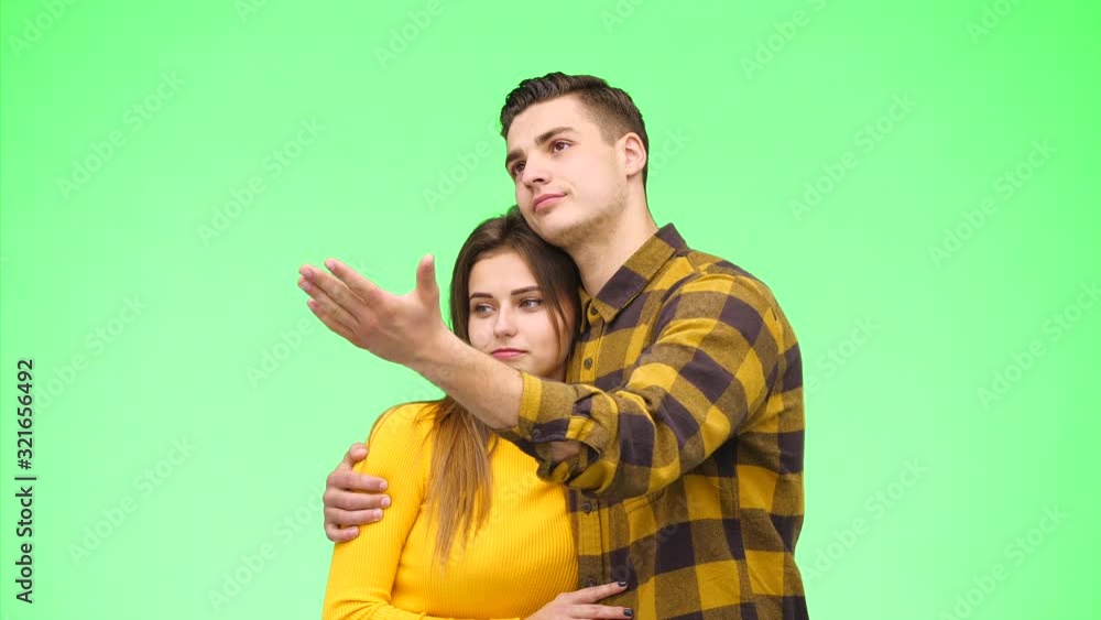 Close up view of young couple pointing fingers together. Close up. Copy space. Crop. 4K. Close up view of young couple pointing fingers together. Close up. Copy space. Crop. 4K.