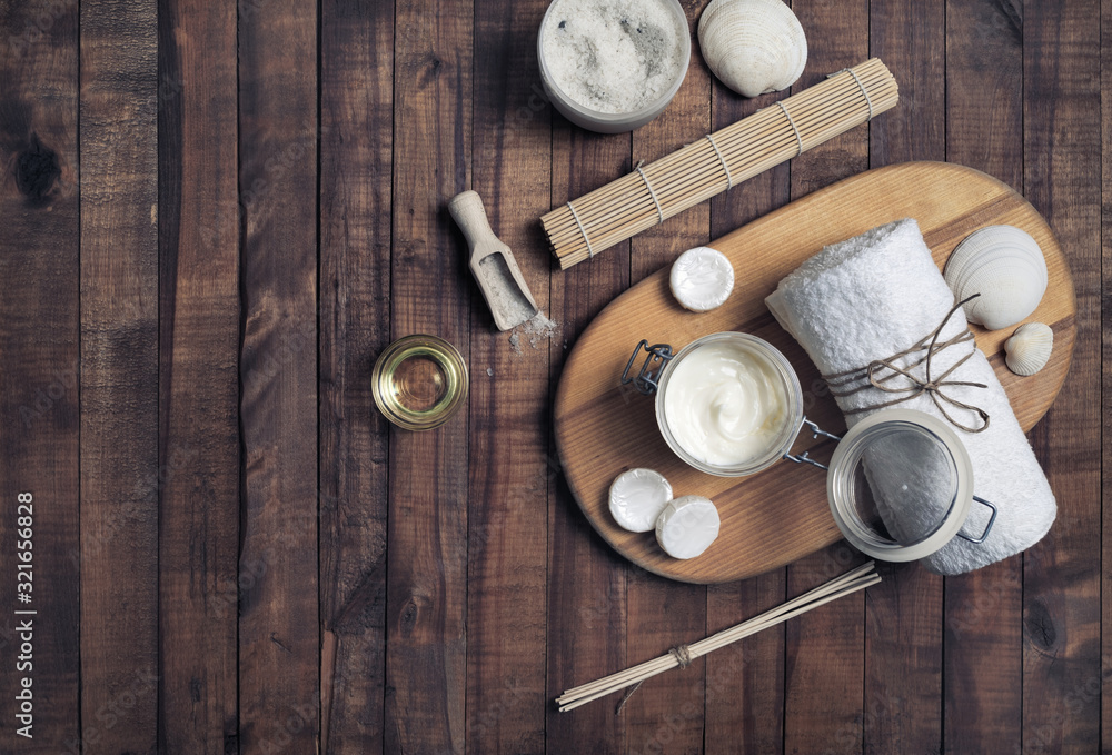 Beauty treatment products on vintage wooden background. Spa cosmetic background. Flat lay.