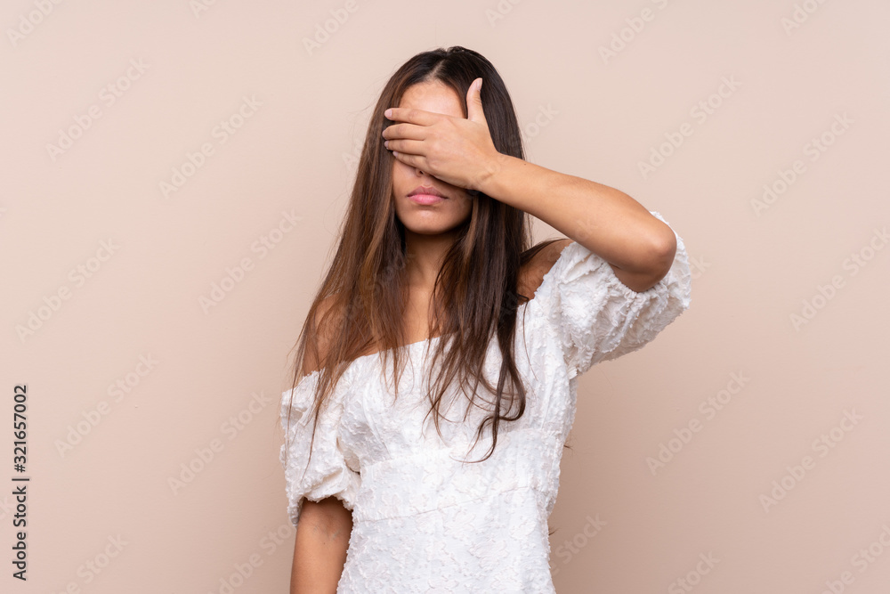 Young Brazilian girl over isolated background covering eyes by hands
