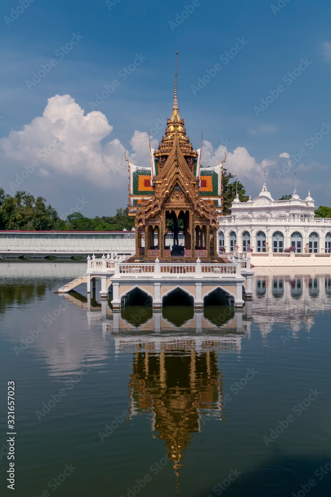 The beautiful Aisawan Dhiphya Asana pavilion inside the Royal Palace of Bang Pa In, Thailand, with reflection on the water
