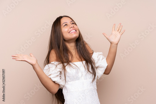 Young Brazilian girl over isolated background with surprise facial expression