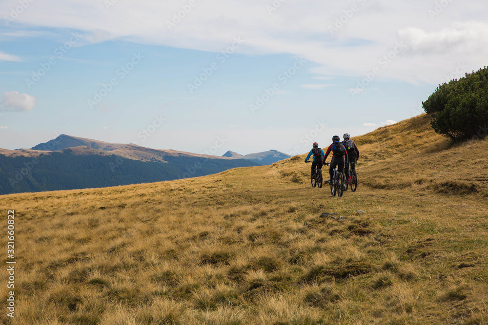 cyclists riding through mountain landscape in Transylvania
