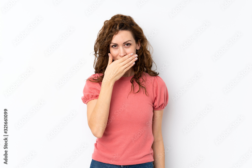 Young pretty woman over isolated background covering mouth with hands Young pretty woman over isolated background covering mouth with hands