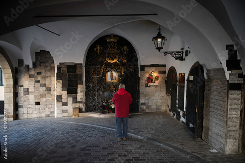 Zagreb   Croatia - December 31   2020   a man praying at stone gate aka kamenita vrata