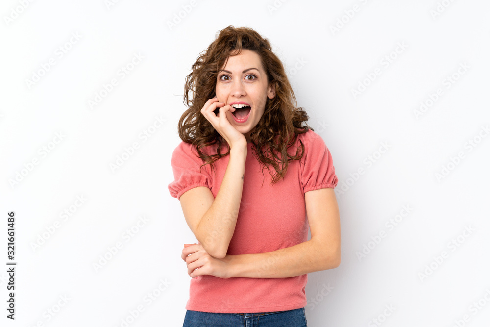 Young pretty woman over isolated background surprised and shocked while looking right Young pretty woman over isolated background surprised and shocked while looking right