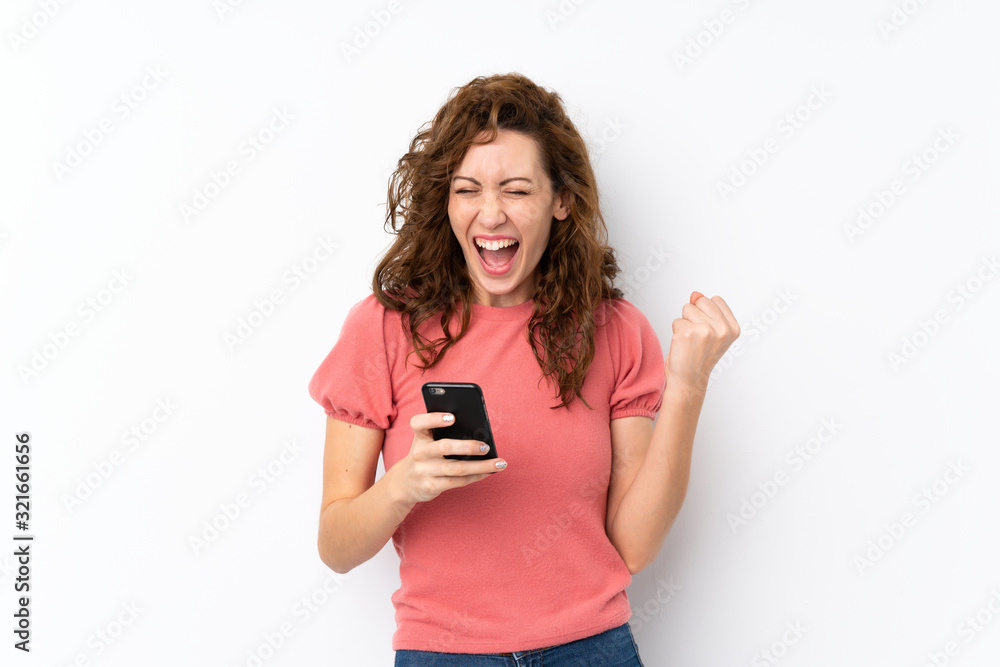 Young pretty woman over isolated background with phone in victory position Young pretty woman over isolated background with phone in victory position