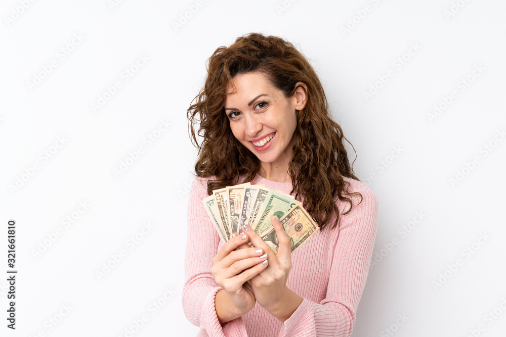 Young pretty woman over isolated background taking a lot of money Young pretty woman over isolated background taking a lot of money