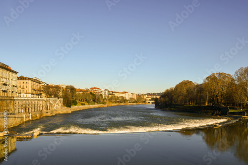 Scenic view of Lungo Po Luigi Cadorna riverside with Murazzi bank and the river park of Borgo Po district in a sunny winter day, Turin, Piedmont, Italy © Simona Sirio