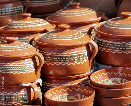 A group of clay pottery, hand made dishes photo