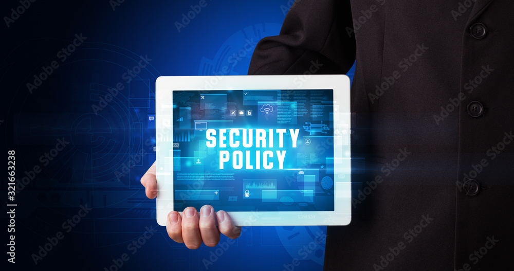 Young business person working on tablet and shows the digital sign: SECURITY POLICY Young business person working on tablet and shows the digital sign: SECURITY POLICY