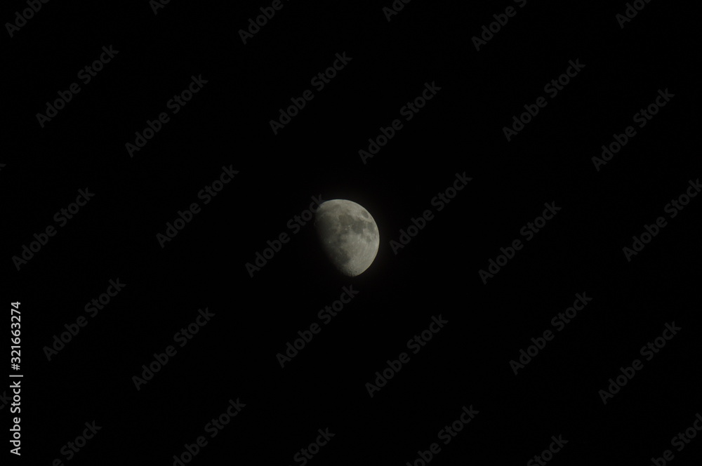 Gey moon over dark black sky at night Gey moon over dark black sky at night
