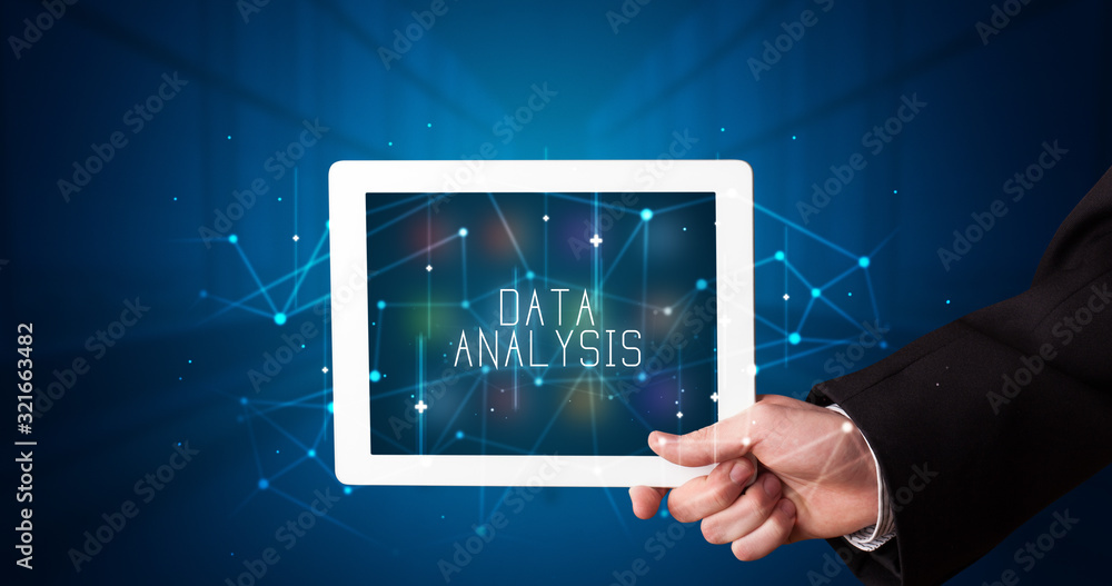 Young business person working on tablet and shows the digital sign: DATA ANALYSIS Young business person working on tablet and shows the digital sign: DATA ANALYSIS