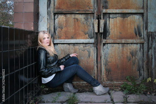 Modern, fashionable girl - blonde sits on the steps in the gateway © lisaveya