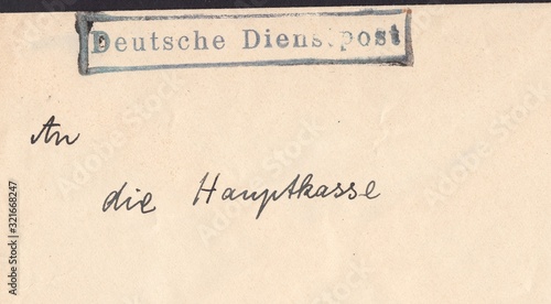 Postal envelope with postmark German service mail. Grey-beige background, circa 1941