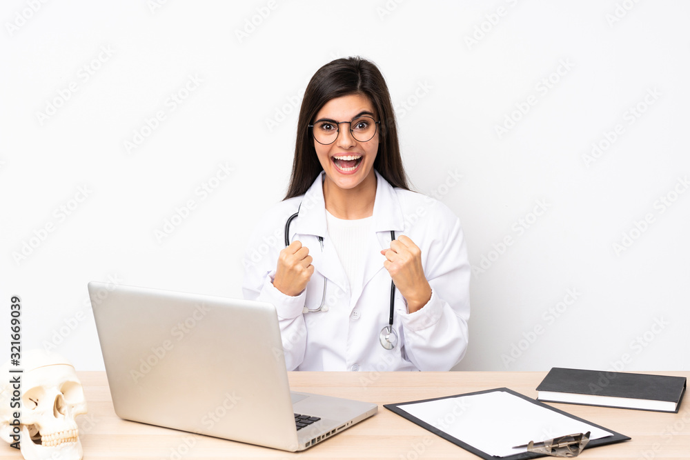 Professional traumatologist in workplace celebrating a victory Professional traumatologist in workplace celebrating a victory