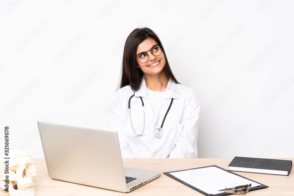 Professional traumatologist in workplace laughing and looking up Professional traumatologist in workplace laughing and looking up