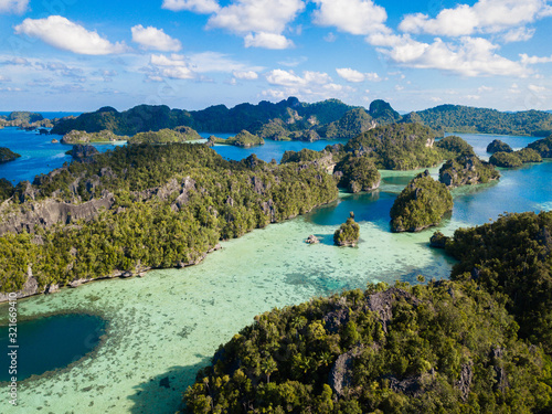 Limestone islands in Raja Ampat, Misool,Indonesia, are surrounded by clear blue waters. photo