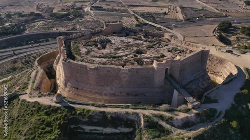 Aerial view of Chinchilla de Montearagon castle with ruined excavated inner building remains surrounded by an outer wall with semi circular towers photo