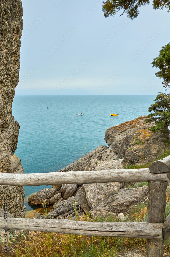 Beautiful bay, fishermen on boats. View from a mountain trail on the Black Sea coast, Novyi Svet village, Crimea