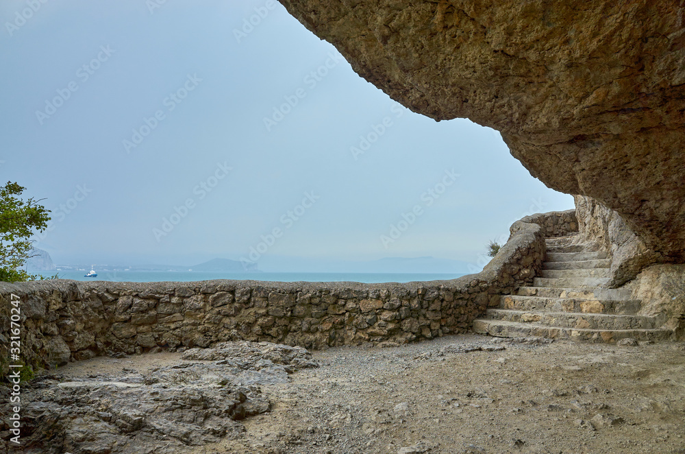 Grotto. A hiking trail along the trail in the mountains of the southern coast of Crimea, a beautiful view of the Black Sea and rocks in the vicinity of the village of Novyi Svet, Republic of Crimea