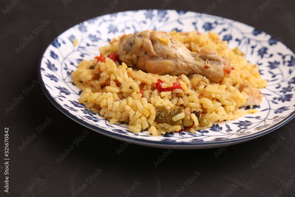 plate of rice with chicken and peppers