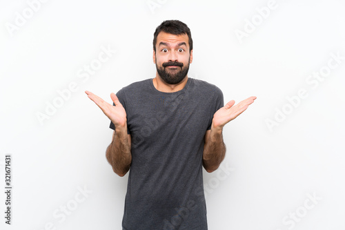 Young handsome man over isolated white background making doubts gesture