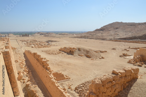 The Mortuary Temple of Hatshepesut, also known as the Djeser-Djeseru, is a mortuary temple of Ancient Egypt located in Upper Egypt. Desert and ruined area around the temple. photo