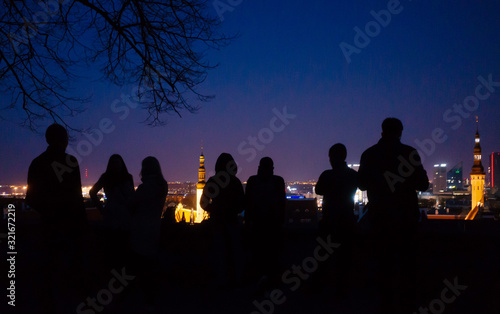 April 20, 2018, Tallinn, Estonia. Silhouettes of tourists on the observation deck in the old city in Tallinn at night.